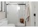 Modern bathroom with glass shower featuring a wooden bench and gray tile at 20349 E Powers Pl, Centennial, CO 80015