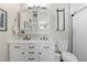 Bathroom vanity with dual sinks, white cabinetry, and marble countertop at 20349 E Powers Pl, Centennial, CO 80015