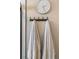 Bathroom wall with towels hanging on a rack and a decorative clock at 20349 E Powers Pl, Centennial, CO 80015