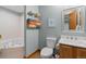Bathroom featuring a bathtub, sink, and a toilet, with shelves with stacked towels above at 20349 E Powers Pl, Centennial, CO 80015