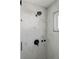 Modern shower with white marble tile, black showerhead, and black accents at 20349 E Powers Pl, Centennial, CO 80015