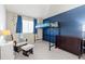 Bright bedroom featuring a loft bed, dark dresser, and a cozy chair with ottoman at 20349 E Powers Pl, Centennial, CO 80015