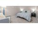 Bedroom with a bed with white covers, carpeted floor, and an elegant armchair at 20349 E Powers Pl, Centennial, CO 80015