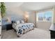 Calming bedroom with a large window, light-colored carpet, and an accent wall mural at 20349 E Powers Pl, Centennial, CO 80015