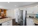 Well-lit kitchen features stainless steel appliances, granite countertops, and ample storage in white cabinets at 20349 E Powers Pl, Centennial, CO 80015