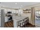 Modern kitchen with stainless steel appliances, granite countertops, and adjacent dining area at 20349 E Powers Pl, Centennial, CO 80015