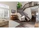 Inviting living room boasts a piano, staircase, and ample natural light at 20349 E Powers Pl, Centennial, CO 80015