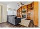 Cozy living room with a fireplace, wood built-in shelves, large windows, and comfortable gray sofa at 20349 E Powers Pl, Centennial, CO 80015