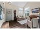 Cozy living room features a grandfather clock, comfortable seating, and large windows at 20349 E Powers Pl, Centennial, CO 80015