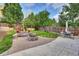 Beautifully landscaped backyard with a fire pit and patio area, ideal for outdoor relaxation at 11670 S Flower Mound Way, Parker, CO 80134
