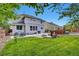 Backyard featuring patio, dining table, fire pit, lush green grass and privacy fence at 11670 S Flower Mound Way, Parker, CO 80134