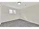 Bedroom features neutral walls, plush carpeting, and dual windows providing ample light at 11670 S Flower Mound Way, Parker, CO 80134