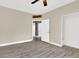 Neutral bedroom with a ceiling fan and multiple closets and doorways at 11670 S Flower Mound Way, Parker, CO 80134