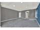 Large carpeted bedroom with recessed lighting and gray walls leading to bathroom at 11670 S Flower Mound Way, Parker, CO 80134
