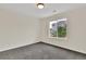 Bright bedroom with large window, neutral paint, and plush gray carpeting at 11670 S Flower Mound Way, Parker, CO 80134