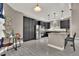Modern kitchen with stainless steel appliances, dark cabinetry, and bright lighting at 11670 S Flower Mound Way, Parker, CO 80134