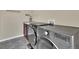 Functional laundry room featuring gray washer and dryer and utility sink at 11670 S Flower Mound Way, Parker, CO 80134