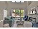 Spacious living room with a fireplace, large windows, and stylish decor at 11670 S Flower Mound Way, Parker, CO 80134