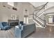 Elegant living room with fireplace, staircase, and open floor plan at 11670 S Flower Mound Way, Parker, CO 80134