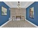 Stylish room featuring vibrant blue walls and neutral-toned wood paneling at 11670 S Flower Mound Way, Parker, CO 80134