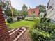 Back yard featuring a lawn, patio, greenery, and stairs leading down into the yard at 2801 Champa St, Denver, CO 80205