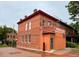 Corner view of the charming brick building showcasing its unique architectural details and classic design at 2801 Champa St, Denver, CO 80205