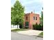 Attractive brick building with a mature tree, set on a well-maintained lawn at 2801 Champa St, Denver, CO 80205
