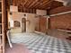 Spacious room with vintage black and white tile, exposed brick, and exposed utilities at 2801 Champa St, Denver, CO 80205