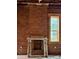 Interior view featuring an original brick fireplace and large window, blending historic charm with natural light at 2801 Champa St, Denver, CO 80205