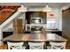 Modern kitchen with stainless steel appliances, dark cabinetry, and a large island, ideal for cooking at 2801 Champa St, Denver, CO 80205