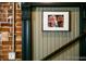 Close up of trim and a framed photo in staircase, featuring black trim against brick and paneled walls at 2801 Champa St, Denver, CO 80205