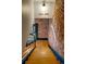 Staircase descending, with brick walls, wooden steps, and industrial-style black metal railings at 2801 Champa St, Denver, CO 80205