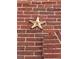 Detail of a decorative star on a red brick wall, adding a unique architectural touch at 2801 Champa St, Denver, CO 80205