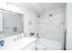 Bright bathroom featuring a combined shower and tub with white subway tiles, a modern vanity, and chrome fixtures at 9155 E Center Ave # 4B, Denver, CO 80247