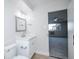 Bright bathroom features a sink, toilet, and open entrance to bedroom with ceiling fan at 9155 E Center Ave # 4B, Denver, CO 80247