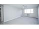 Bright bedroom with light gray walls and new carpet featuring a window and ceiling fan at 9155 E Center Ave # 4B, Denver, CO 80247