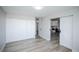 Spacious bedroom with a large closet, modern barn door, and connecting view of the kitchen and dining area at 9155 E Center Ave # 4B, Denver, CO 80247