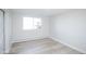 Clean and bright bedroom with light wood floors, a large window, and neutral wall color for a serene atmosphere at 9155 E Center Ave # 4B, Denver, CO 80247