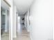 Bright hallway with light wood floors, mirrored closet door, and an open view into the living area at 9155 E Center Ave # 4B, Denver, CO 80247