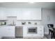 Modern kitchen with white cabinets, stainless steel appliances, and quartz countertops at 9155 E Center Ave # 4B, Denver, CO 80247