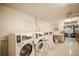 The updated laundry room is bright and clean for community use at 9155 E Center Ave # 4B, Denver, CO 80247