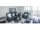 Cozy living room featuring a black leather sofa set, area rug, and a sliding glass door for ample natural light at 9155 E Center Ave # 4B, Denver, CO 80247