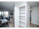 Open shelving in the living space with hard wood floors and access to the kitchen at 9155 E Center Ave # 4B, Denver, CO 80247