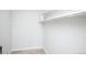 Empty walk-in closet with clean white walls, light wood flooring, and shelving, ready for organization at 9155 E Center Ave # 4B, Denver, CO 80247