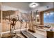 Basement featuring work out equipment, massage table, decorative lighting, and bright accent wall at 14115 Blue Stem St, Broomfield, CO 80020