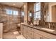Bathroom with dual sink vanity, tiled walls, and a large mirror, and great natural light at 14115 Blue Stem St, Broomfield, CO 80020