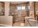 Bathroom with a glass-enclosed shower, tiled walls, and a modern vanity at 14115 Blue Stem St, Broomfield, CO 80020