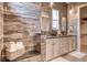 This bathroom features a double vanity, decorative mirrors, stylish light fixtures, and a luxurious tiled shower at 14115 Blue Stem St, Broomfield, CO 80020
