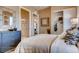 Bright bedroom with modern decor, including stylish dresser, closet, and unique wall art at 14115 Blue Stem St, Broomfield, CO 80020