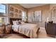 Comfortable bedroom with large windows, a decorative headboard, a dresser, and stylish design at 14115 Blue Stem St, Broomfield, CO 80020